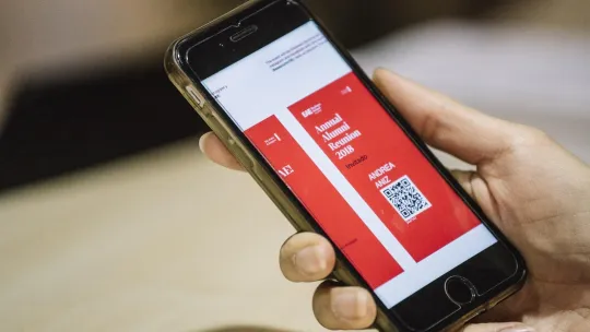 EAE Business School student holding a mobile