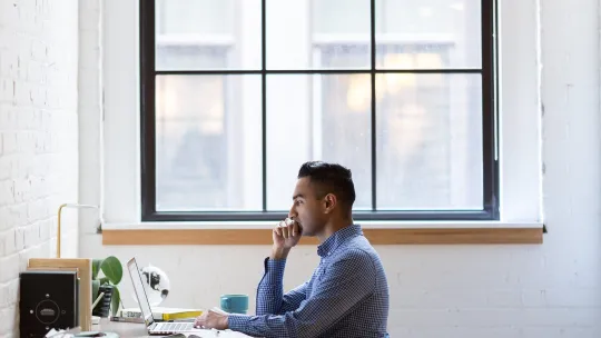 Student researching at his desk 