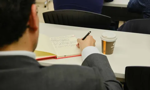 EAE Business School lecturer taking notes