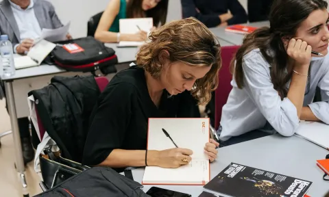Student taking notes at EAE Business School